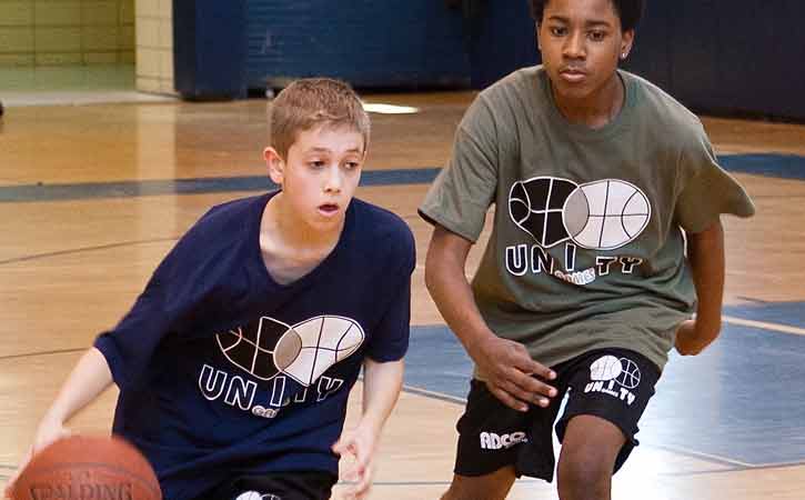 2 boys playing basketball
